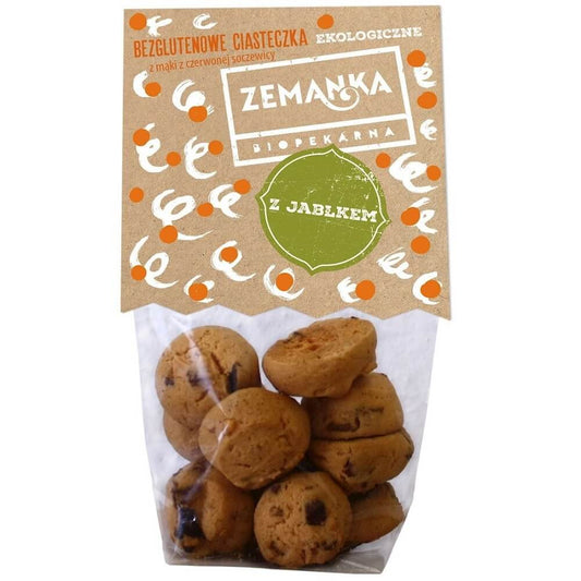 Glutenfreie Kekse aus rotem Linsenmehl mit Apfel, 100 g, von ZEMANKA, auf einem weißen Teller mit Apfelstücken.