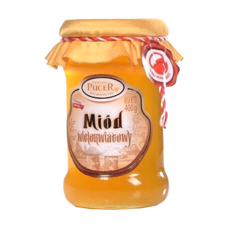 Honigglas mit Blütenhonig von PASIEKA PUCER, 400g, goldene Farbe und natürliche Konsistenz, auf einem Holzuntergrund.
