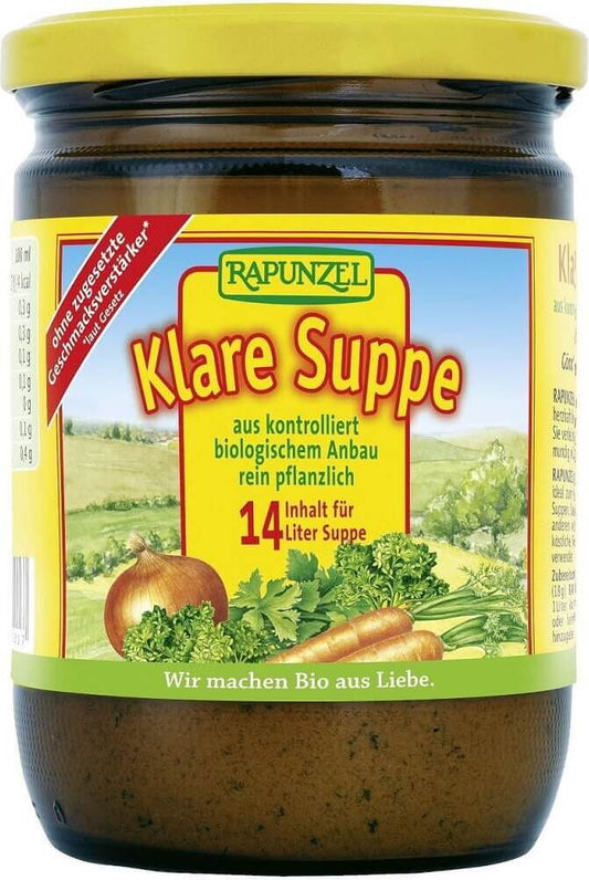 Bio-Gemüsebrühe von RAPUNZEL in einer 250 g Packung, gezeigt in einer offenen Verpackung mit frischen Gemüsesorten