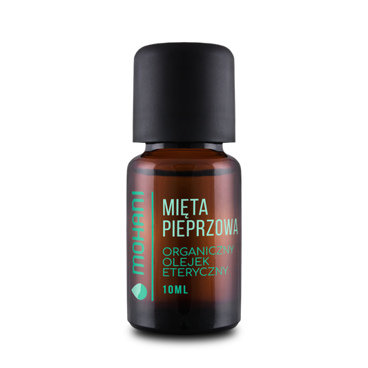Ätherisches Bio-MOHANI-Pfefferminzöl in Flasche, frischer grüner Pfefferminzblatt im Hintergrund, naturbelassenes Aromaöl
