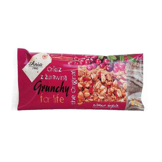 Dinkelgrütze Riegel mit Cranberry von ANIA, 65 g, zeigt den Riegel mit Cranberry-Früchten und Dinkelkörnern in der Verpackung.