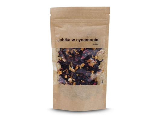 Frischer Apfeltee in Zimt von VIVIO, 50g, zeigt eine Teetasse mit Apfelstücken und Zimtstangen auf einer Holzoberfläche.