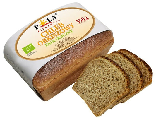 Vollkorn Dinkelbrot von Piekarnia Pola, 350 g, frisch gebacken, goldbraun und knusprig, auf einem rustikalen Holzbrett.