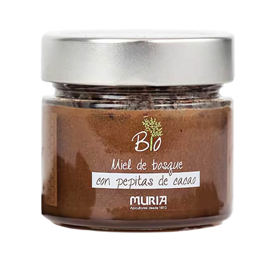 BIO Waldhonig mit Kakaobohnen von MURIA, 250 g, zeigt ein Glas mit goldgelbem Honig und Kakaobohnen im Hintergrund